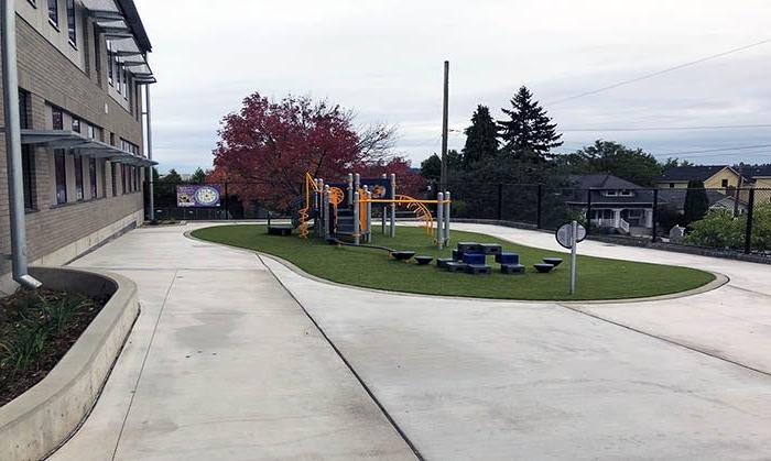 a play area on grass in the middle of concrete